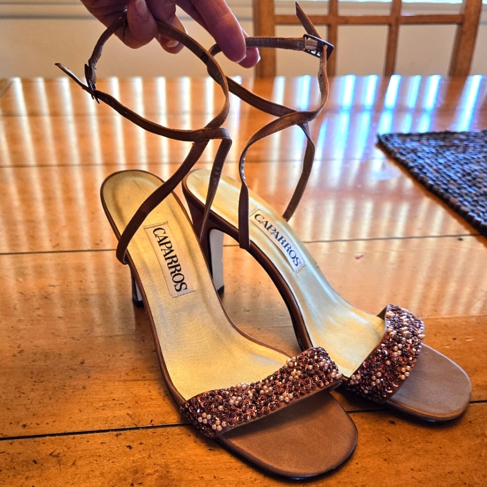 Bronze Caparros beaded fabric heels.